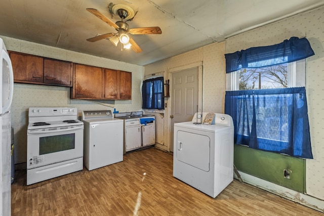 kitchen with washer / dryer, wallpapered walls, light wood-style floors, and white electric range