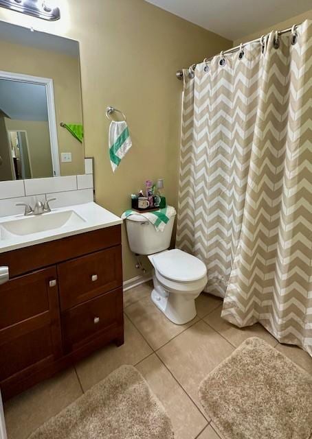 full bath with toilet, a shower with curtain, vanity, and tile patterned floors