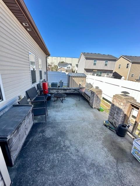 view of patio / terrace with a residential view and a fenced backyard