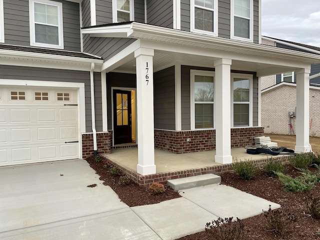 doorway to property featuring covered porch and brick siding