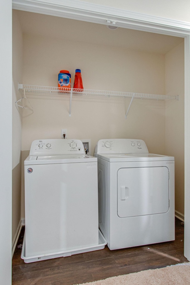 clothes washing area with independent washer and dryer and wood finished floors