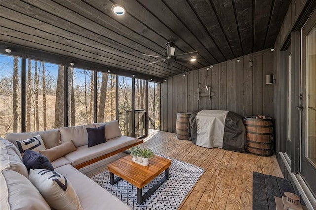 sunroom / solarium featuring wooden ceiling and a ceiling fan