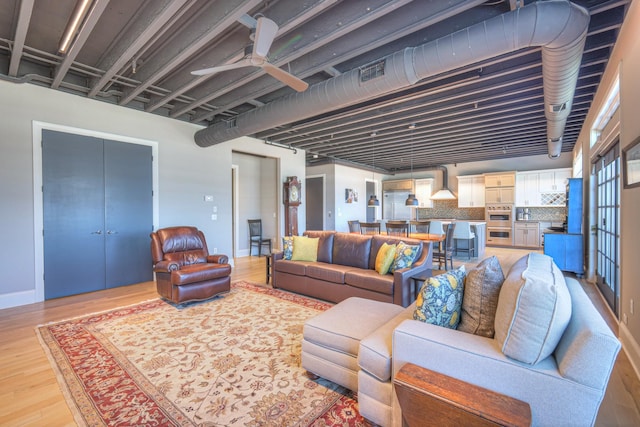 320 Liberty Pike Unit 212, Franklin, TN 37064 - living room with baseboards, visible vents, and light wood-style flooring