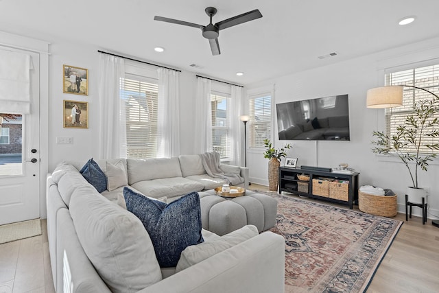 living area featuring recessed lighting, visible vents, and light wood-style flooring