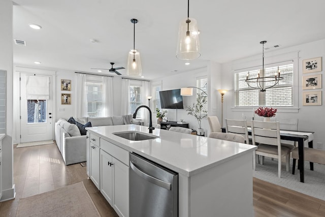 kitchen featuring dark wood-style floors, visible vents, open floor plan, a sink, and dishwasher