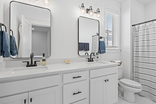 bathroom featuring double vanity, a sink, toilet, and a shower with curtain