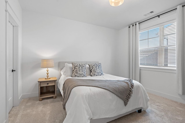 carpeted bedroom with baseboards and visible vents