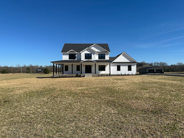 modern inspired farmhouse featuring covered porch, a front lawn, and board and batten siding