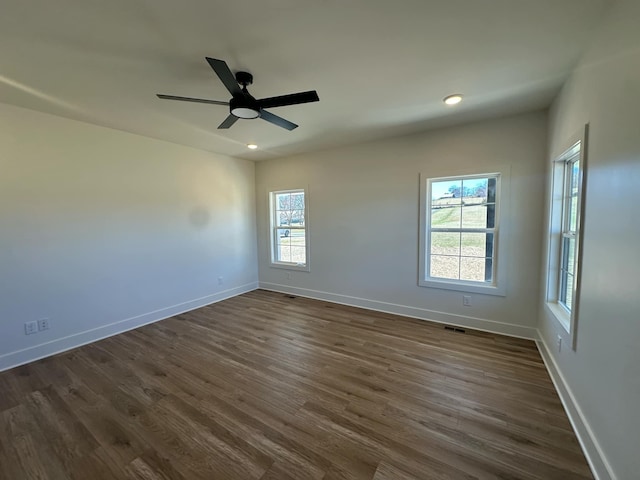 spare room featuring ceiling fan, dark wood-type flooring, recessed lighting, and baseboards