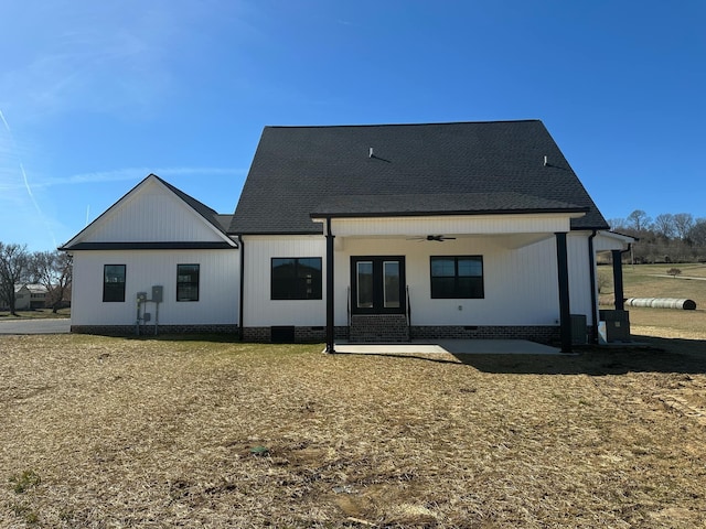 rear view of property with a shingled roof, crawl space, a patio area, and ceiling fan