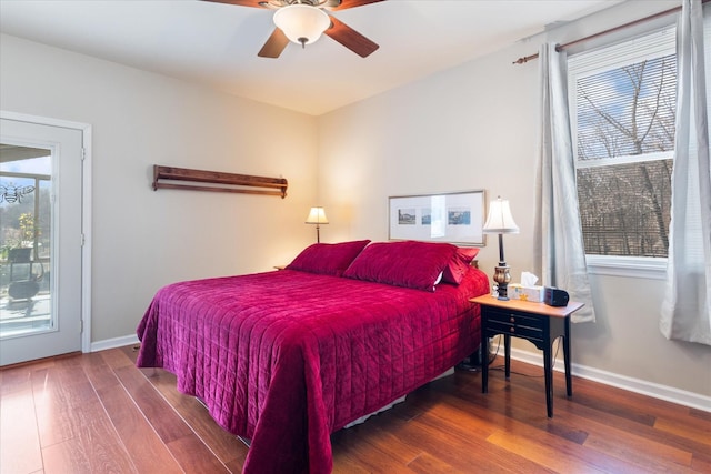 bedroom featuring a ceiling fan, baseboards, and wood finished floors