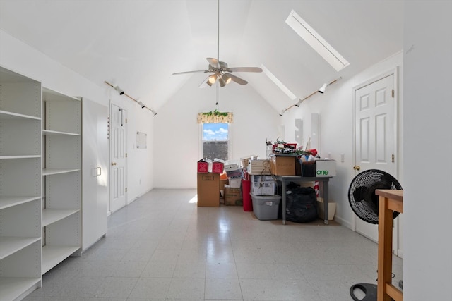 interior space with lofted ceiling with skylight and ceiling fan