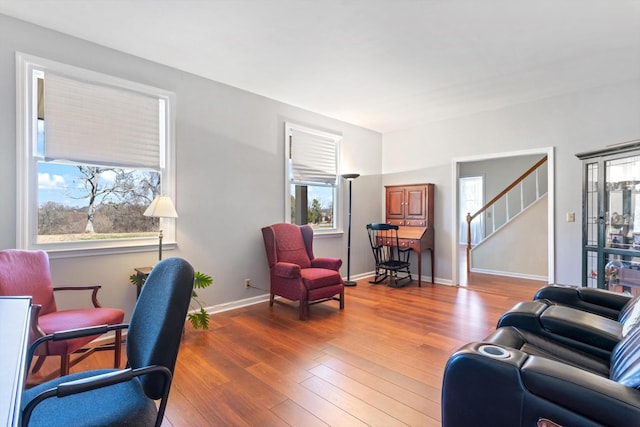 living room with hardwood / wood-style flooring, stairway, and baseboards