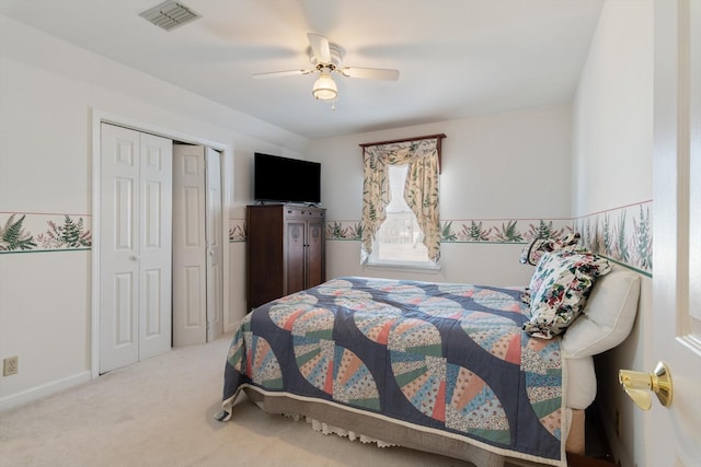 carpeted bedroom featuring a closet, visible vents, ceiling fan, and baseboards