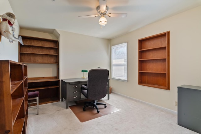 office area featuring carpet floors, baseboards, and a ceiling fan