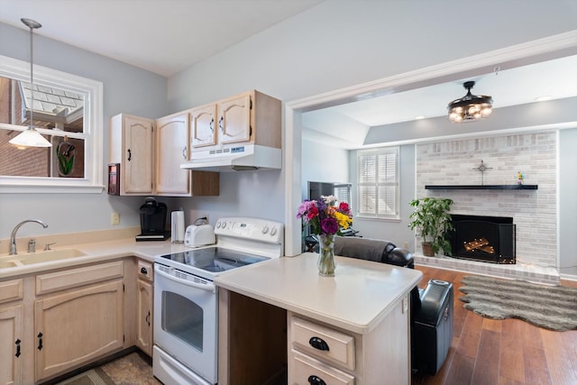 kitchen featuring white range with electric stovetop, open floor plan, under cabinet range hood, light brown cabinets, and a sink