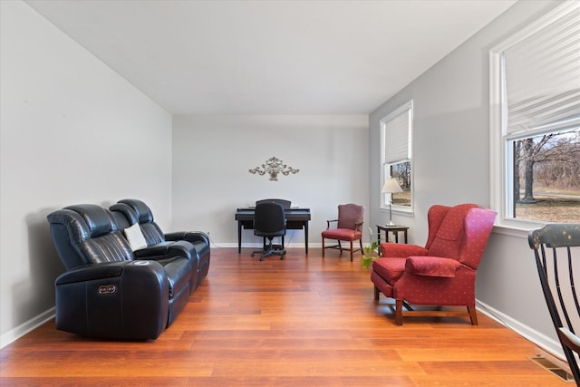 sitting room with visible vents, baseboards, and wood finished floors