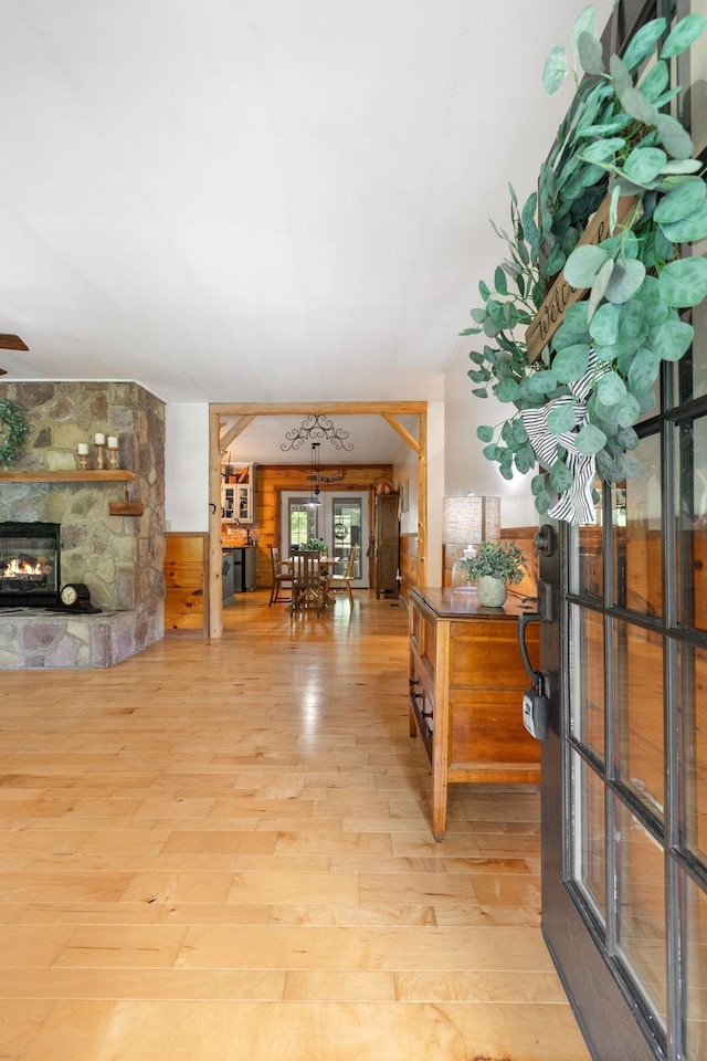 foyer featuring wood finished floors and a stone fireplace