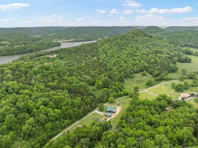 drone / aerial view featuring a water view and a forest view