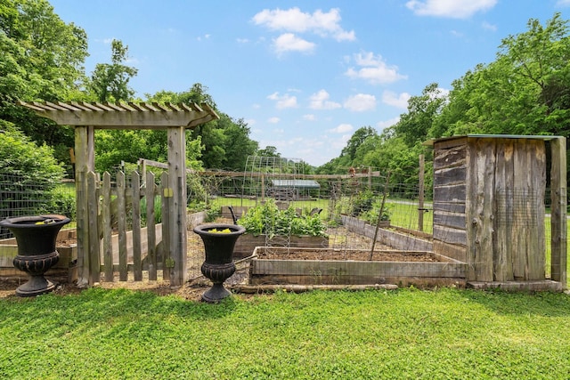 view of yard featuring fence and a garden