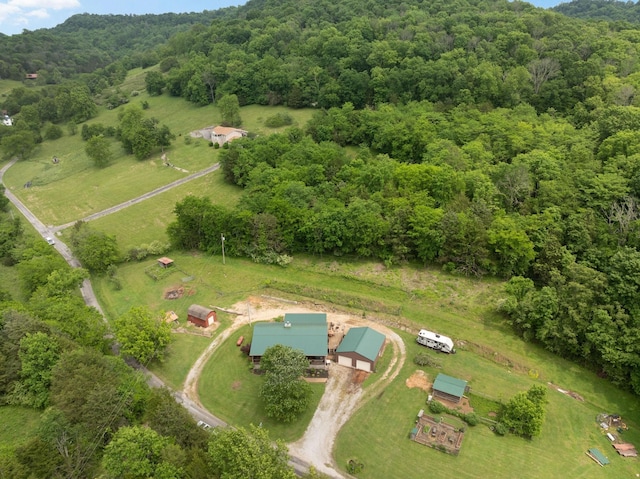 birds eye view of property with a wooded view and a rural view