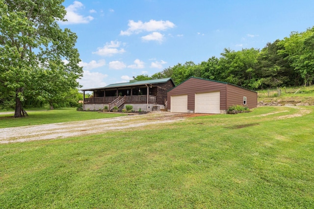 view of front of property featuring an outbuilding, covered porch, driveway, and a front lawn