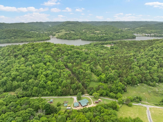 drone / aerial view with a water view and a wooded view