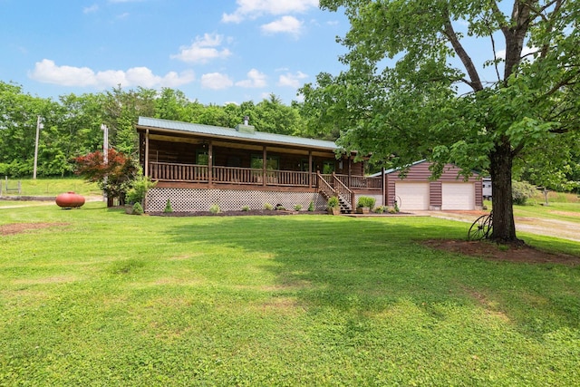 view of front of home featuring an outbuilding, a porch, a garage, driveway, and a front lawn