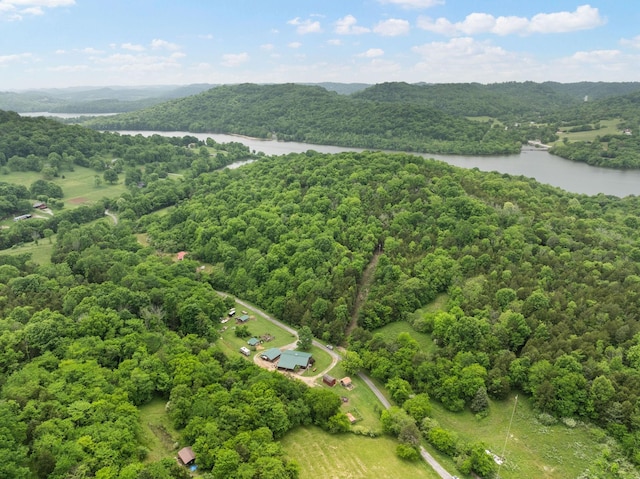 aerial view with a water view and a forest view