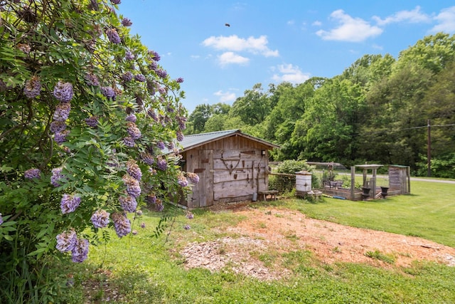 view of yard with a garden, a storage unit, and an outdoor structure