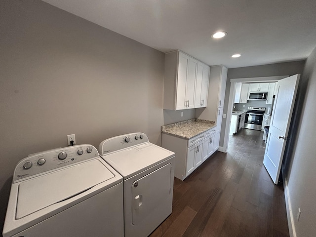 laundry area with recessed lighting, dark wood-style flooring, baseboards, cabinet space, and washing machine and clothes dryer