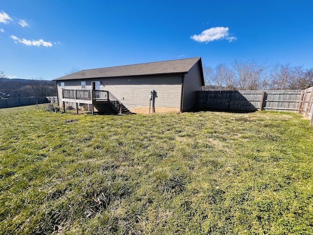 exterior space with a fenced backyard and stairway