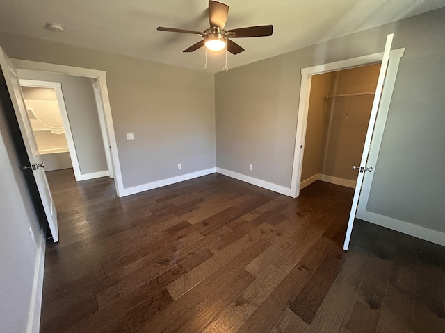 unfurnished bedroom with dark wood-style floors, ceiling fan, and baseboards