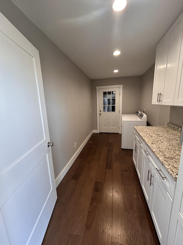 washroom with dark wood finished floors, washer and clothes dryer, recessed lighting, cabinet space, and baseboards