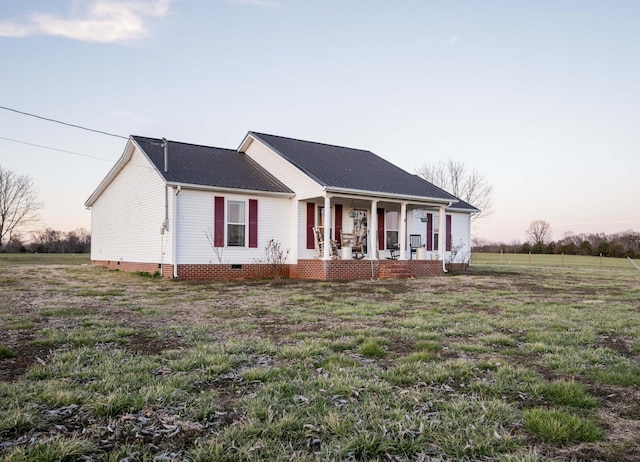 ranch-style home featuring crawl space, covered porch, and metal roof