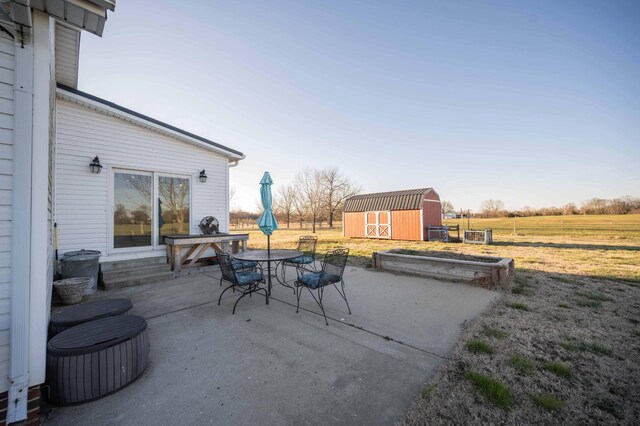 view of patio / terrace featuring an outdoor structure and a storage shed