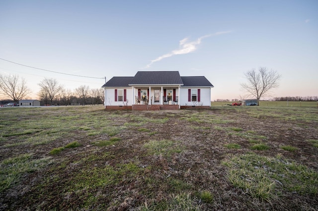 view of front of home featuring metal roof and a porch