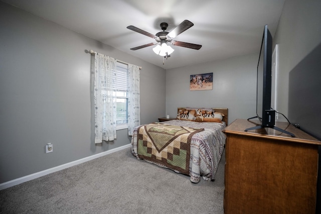 carpeted bedroom with a ceiling fan and baseboards