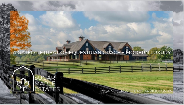 view of community featuring fence, a lawn, and a rural view