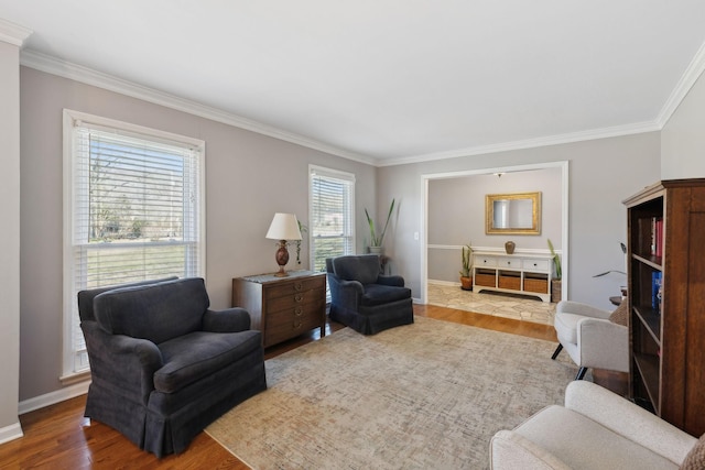 living area with baseboards, wood finished floors, and crown molding