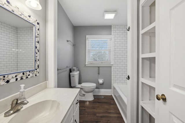 full bathroom featuring visible vents, toilet, vanity, wood finished floors, and baseboards