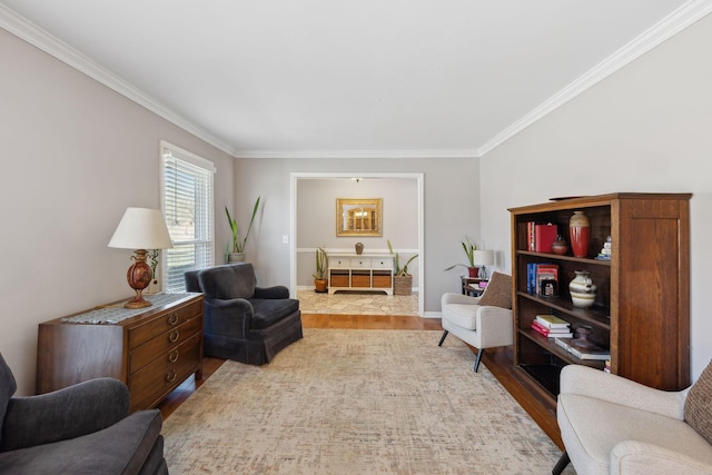 sitting room featuring ornamental molding, baseboards, and wood finished floors