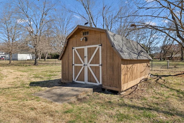 view of shed featuring fence