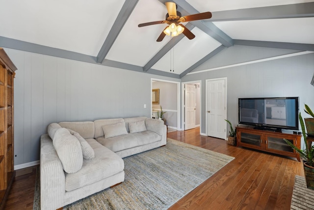 living area with vaulted ceiling with beams, hardwood / wood-style flooring, baseboards, and a ceiling fan