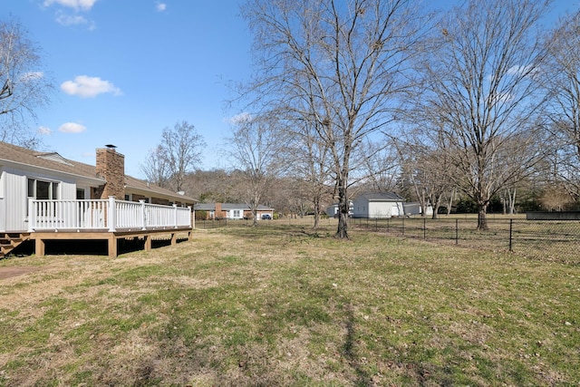 view of yard with fence and a wooden deck