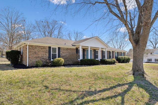 view of front of home featuring a front yard and brick siding