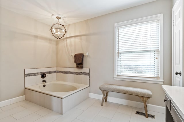 full bathroom featuring a garden tub, plenty of natural light, visible vents, and vanity