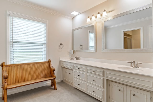 bathroom with double vanity, ornamental molding, a sink, and a shower with shower door