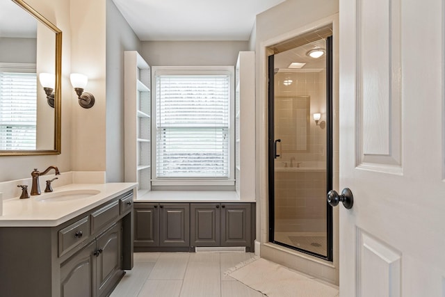 bathroom featuring a shower stall, vanity, and tile patterned floors