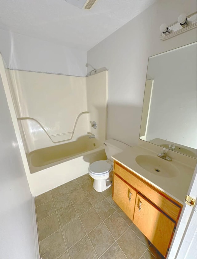 bathroom with toilet, vanity, washtub / shower combination, and tile patterned floors